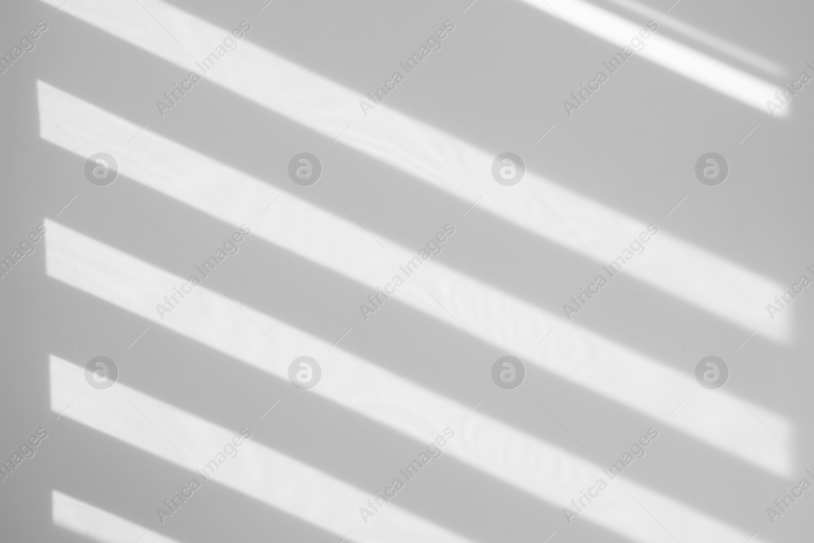 Image of Light and shadows falling on white wall