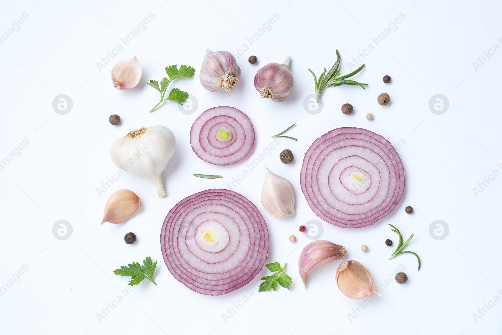 Photo of Fresh garlic, onion rings and spices on white table, flat lay