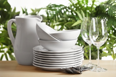 Set of clean dishes on blurred background