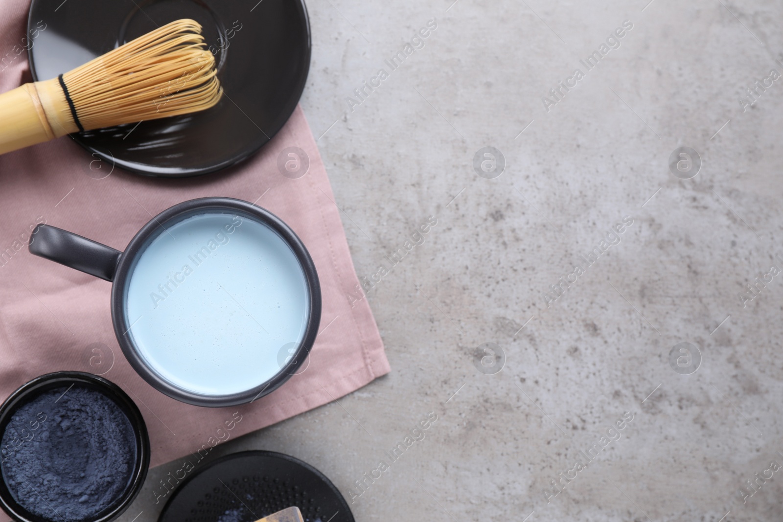 Image of Flat lay composition with blue matcha latte on grey table. Space for text