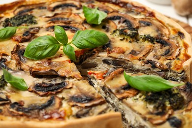 Photo of Delicious quiche with mushrooms and basil, closeup