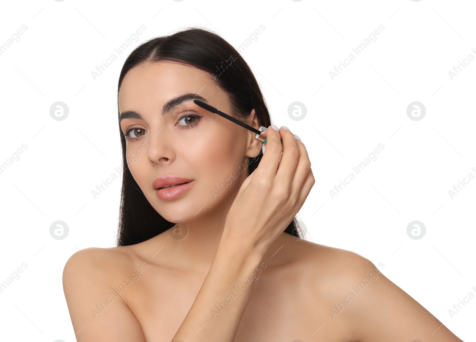 Photo of Beautiful young woman applying mascara on white background