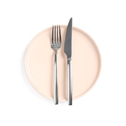 Clean plate with shiny cutlery on white background, top view