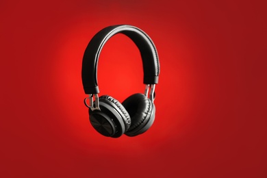 Photo of Stylish headphones with pads on color background