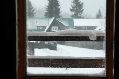 Photo of View of beautiful landscape through window. Winter vacation
