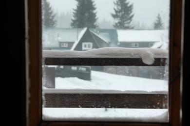 View of beautiful landscape through window. Winter vacation