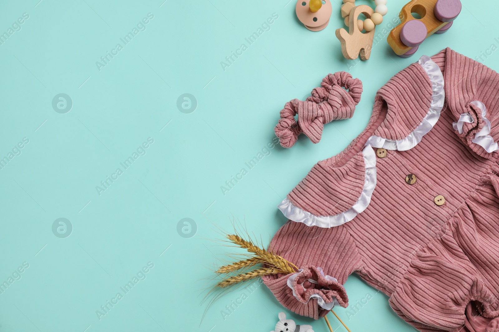 Photo of Flat lay composition with baby clothes and accessories on light blue background, space for text