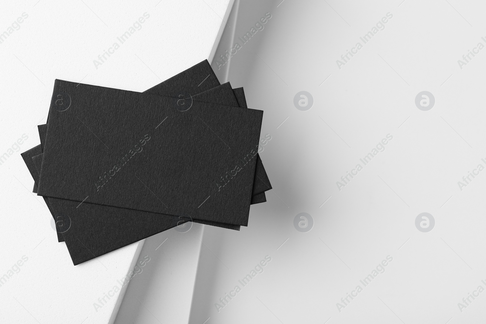 Photo of Blank black business cards on light background, top view. Mockup for design