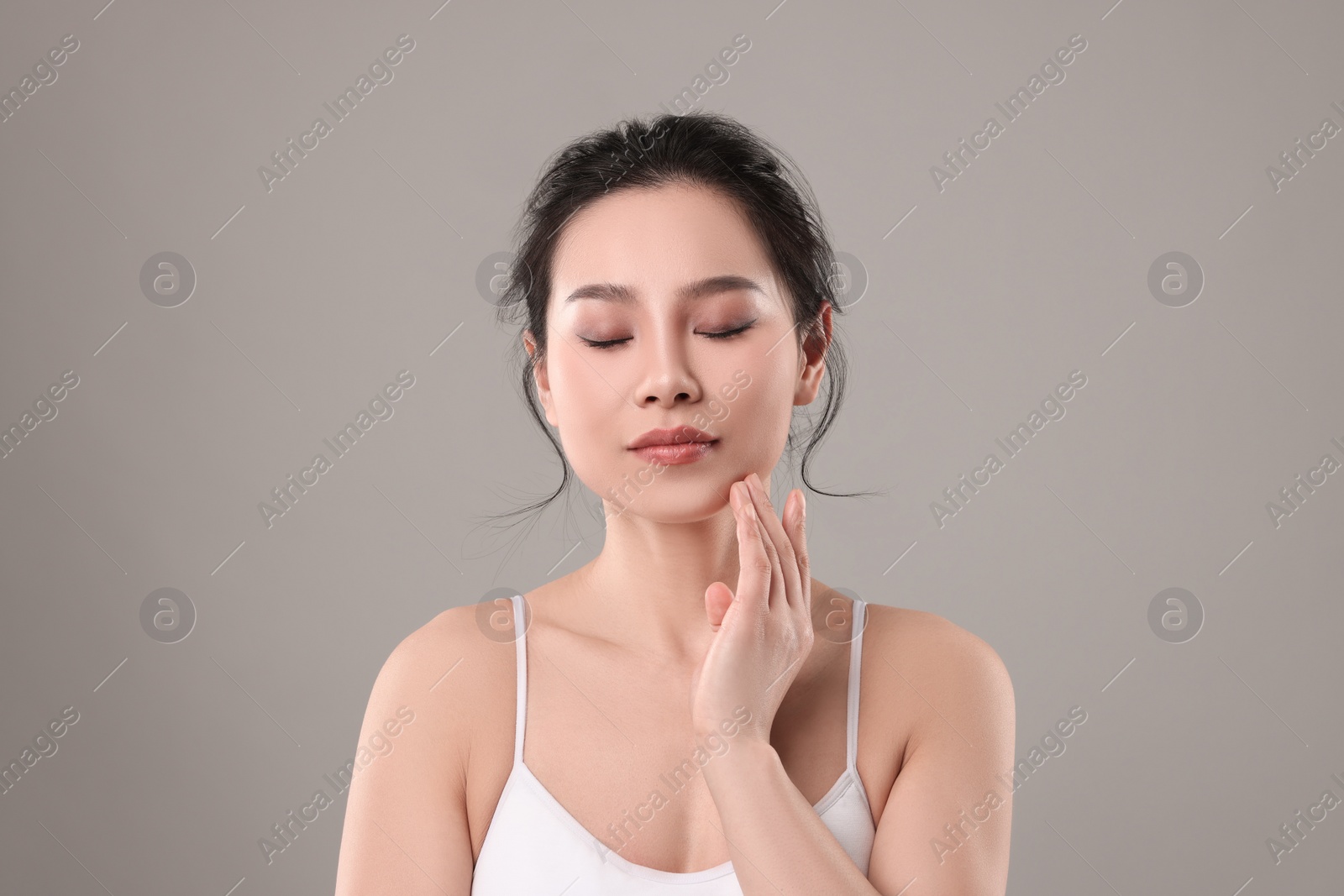 Photo of Portrait of beautiful woman on grey background