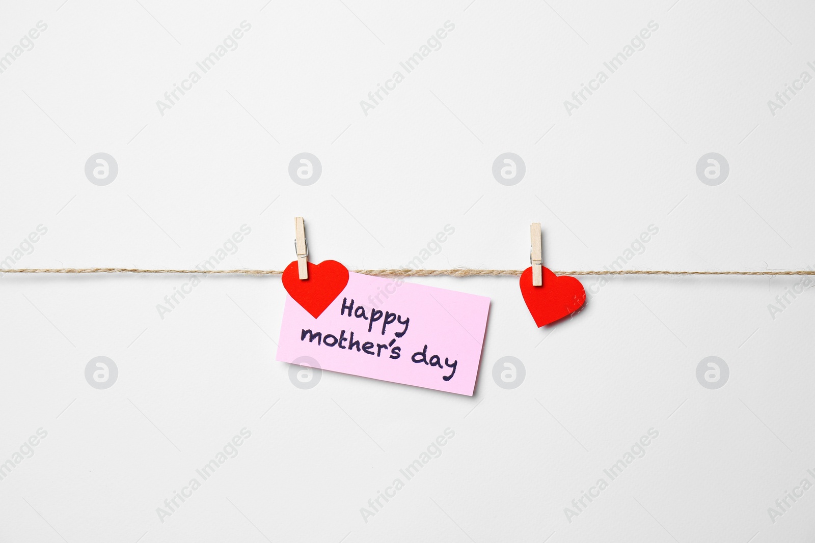 Photo of Greeting card with phrase "HAPPY MOTHER'S DAY" hanging on rope against white background