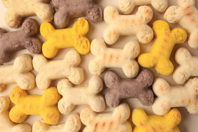 Flat lay composition with many bone shaped vitamins for pets on beige background