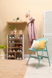 Stylish dressing room interior with shoes in storage unit