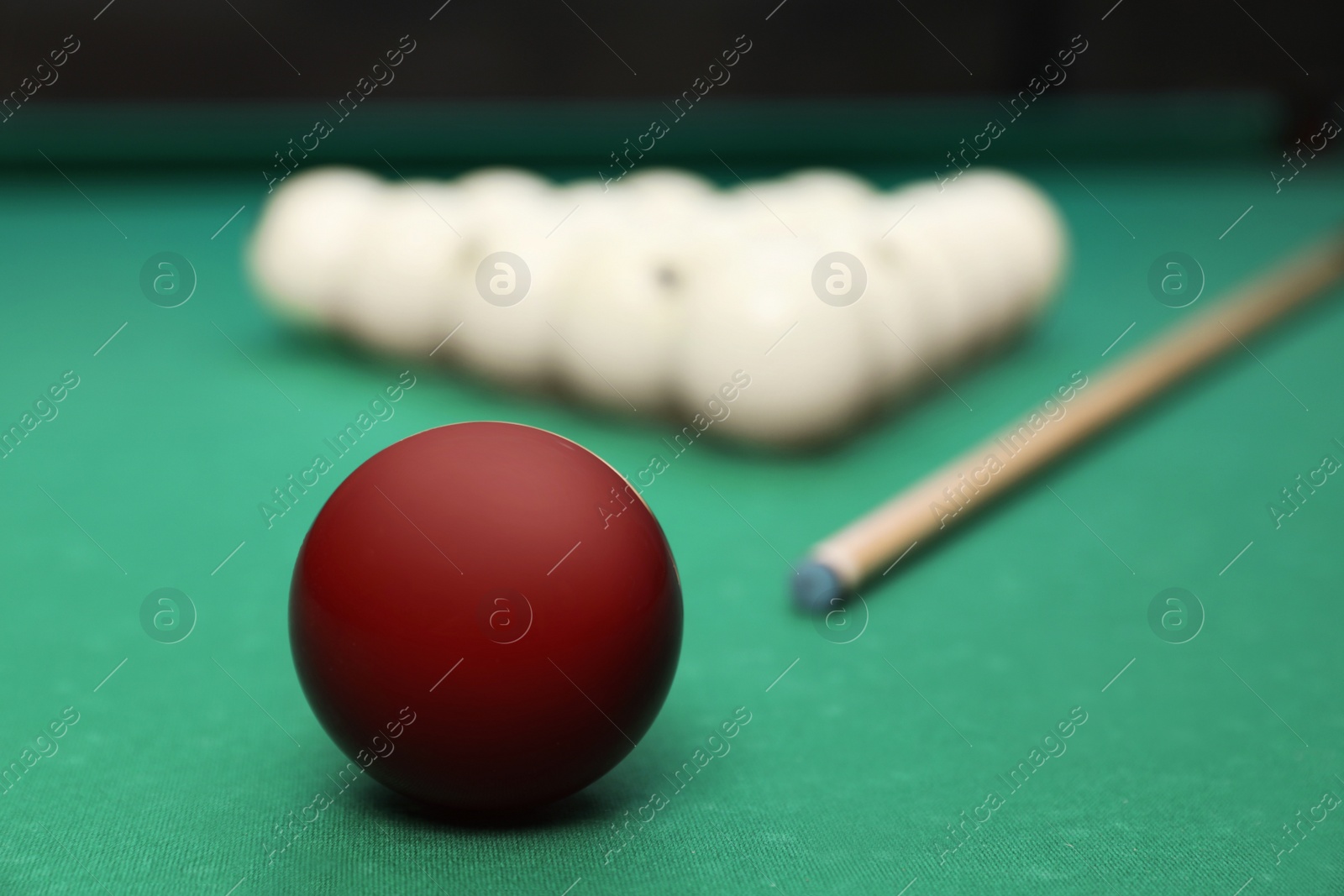 Photo of Billiard balls and cue on table indoors, closeup. Space for text