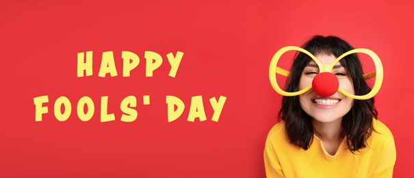 Image of Funny woman with large glasses and clown nose on red background, banner design. Happy fool's day