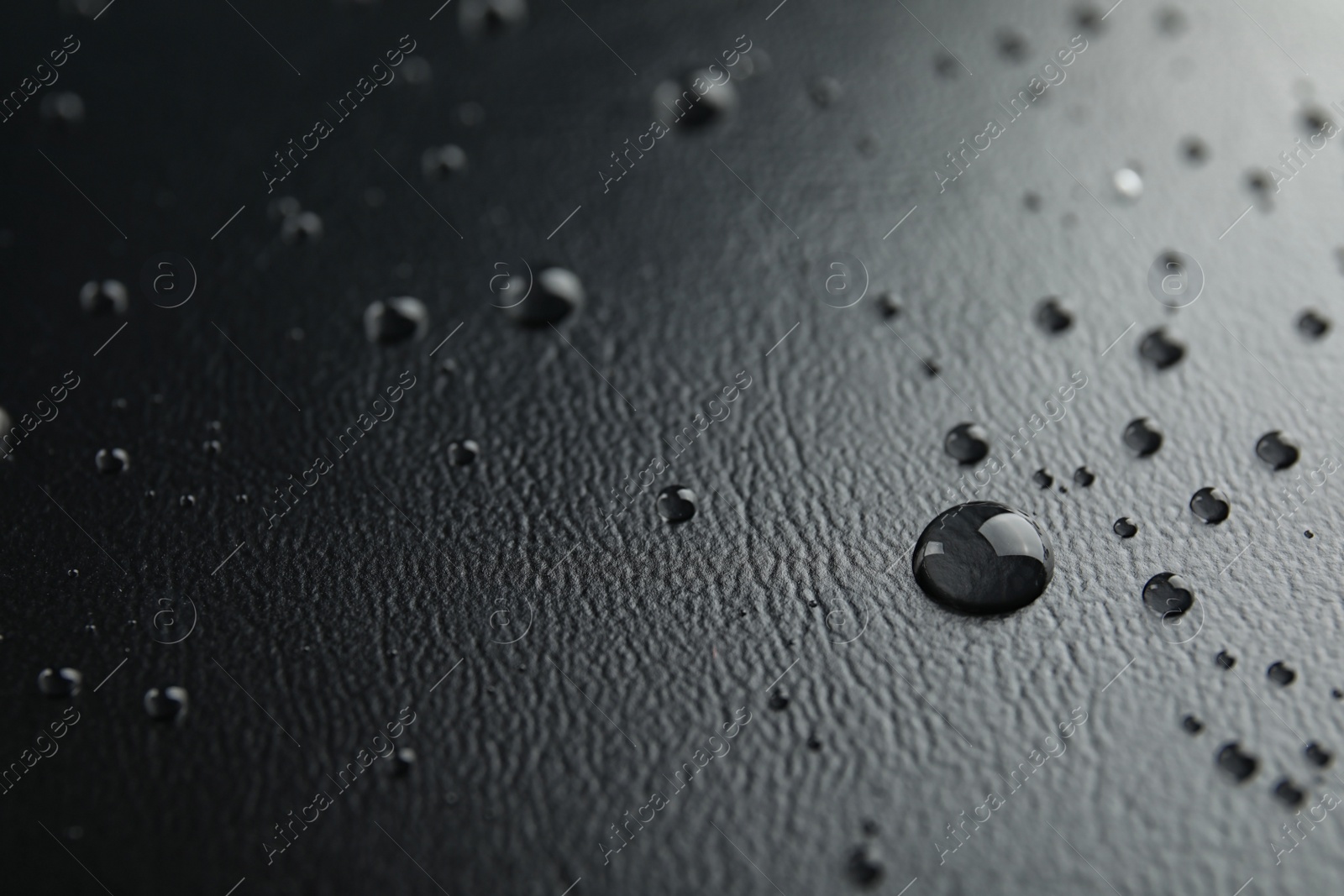 Photo of Many clean water drops on black background