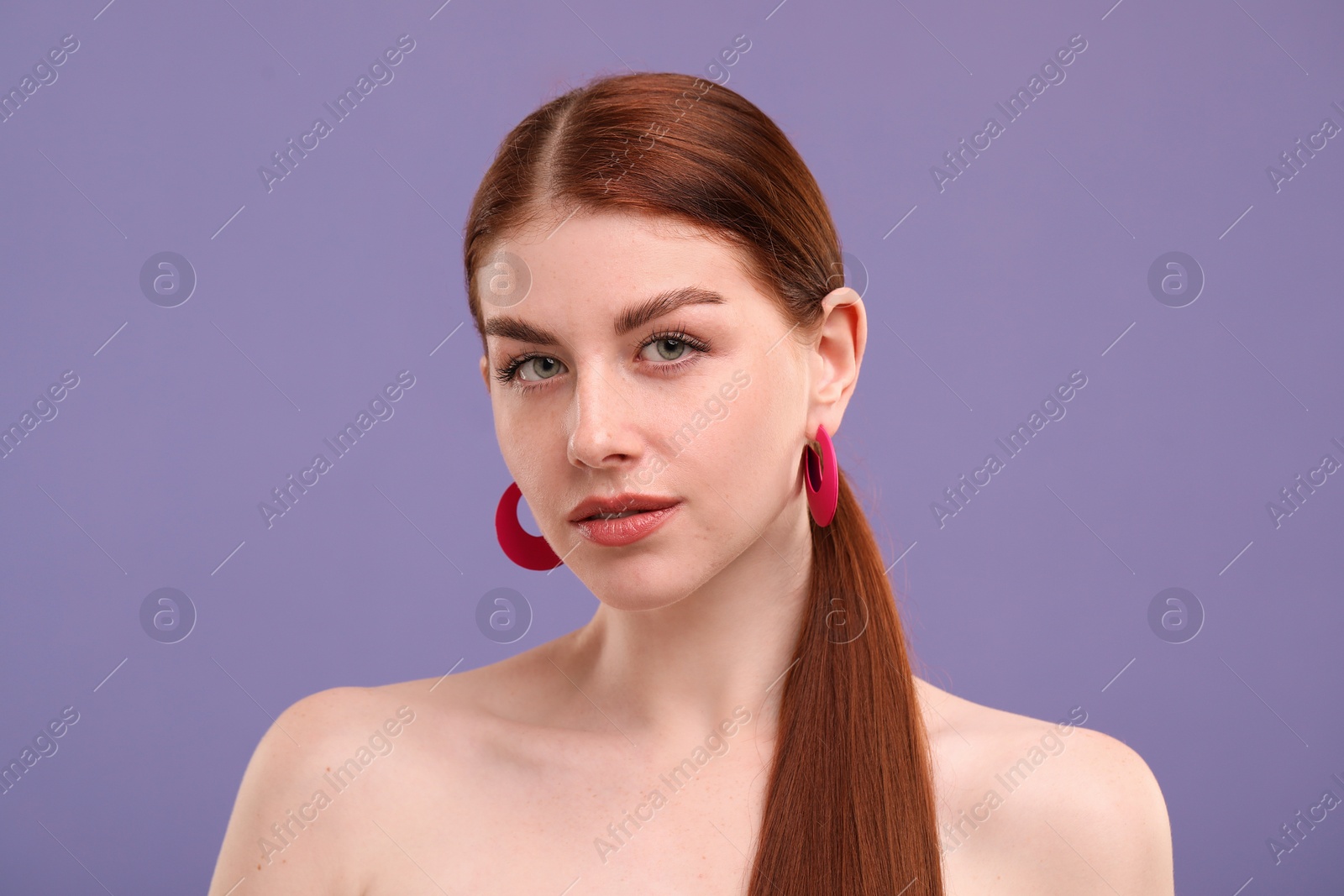 Photo of Portrait of beautiful woman with freckles on purple background