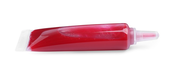 Photo of Tube with red food coloring on white background