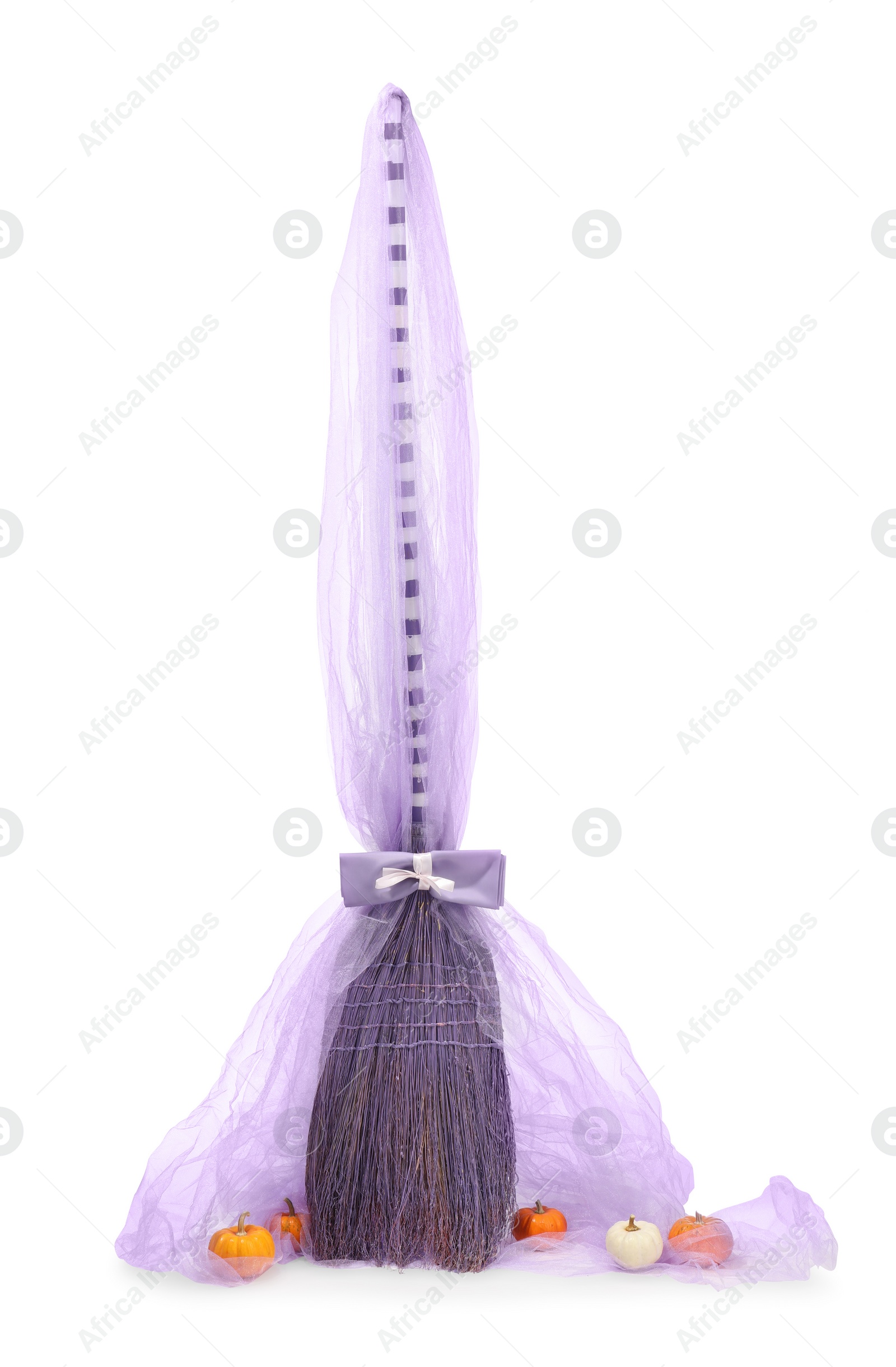 Photo of One beautiful witch's broom with tulle and decorative pumpkins isolated on white