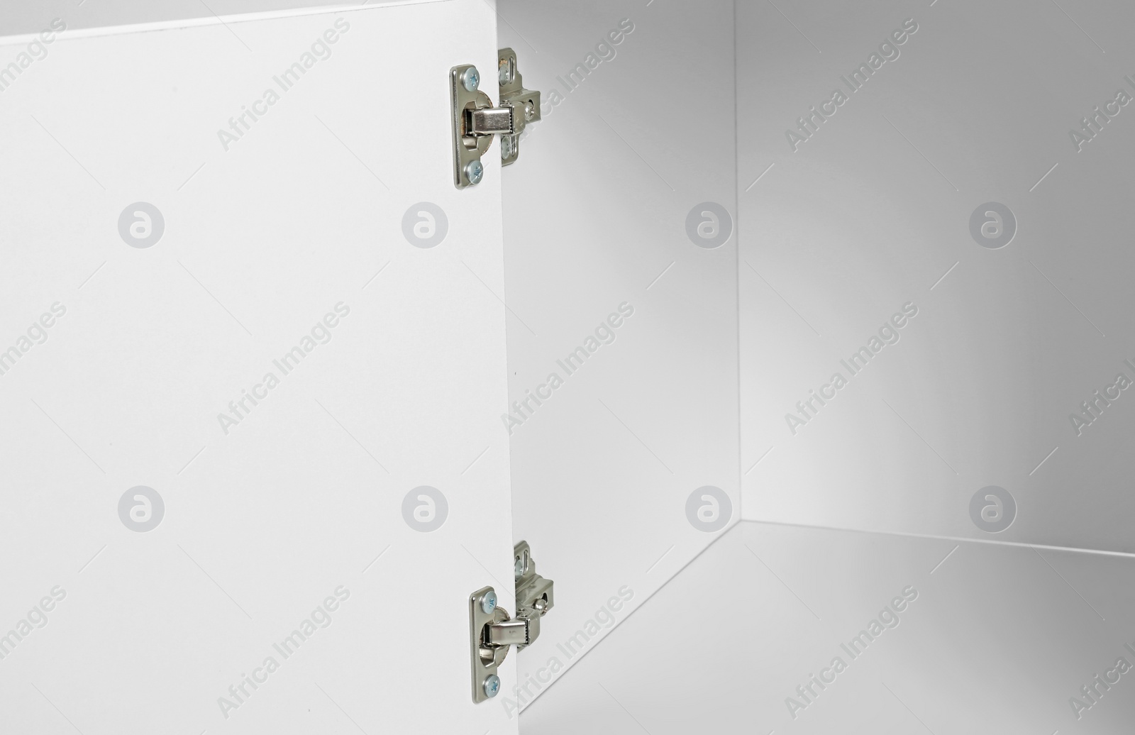 Photo of Empty white cabinet with open door, closeup. Furniture for wardrobe room