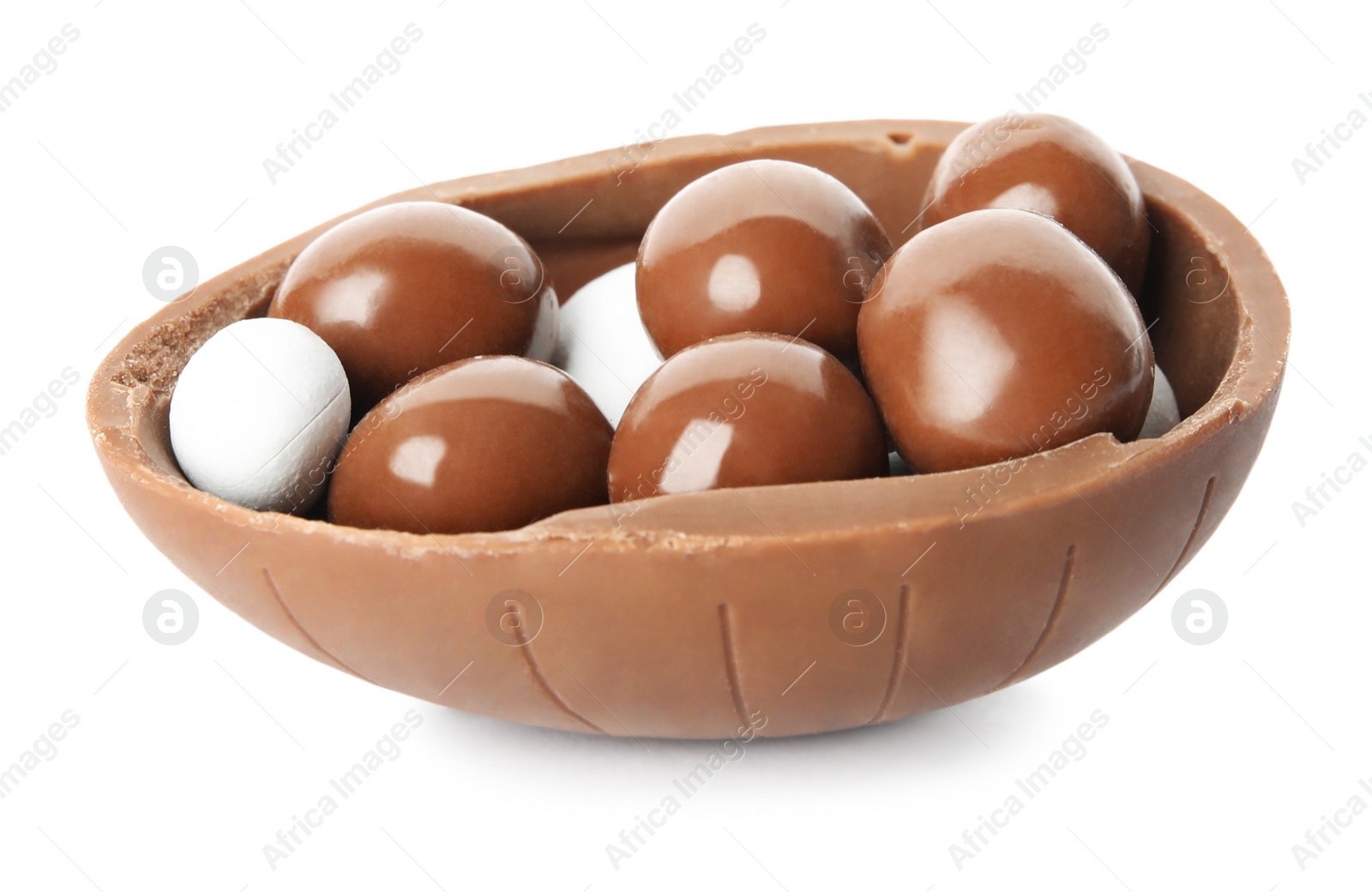 Photo of Half of tasty chocolate egg with candies on white background