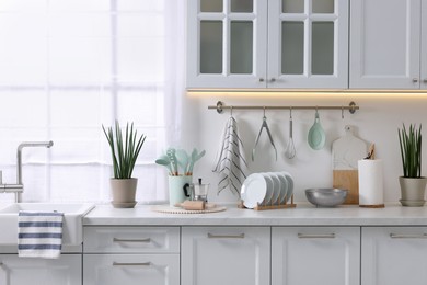 Photo of Set of different utensils and dishes on countertop in kitchen