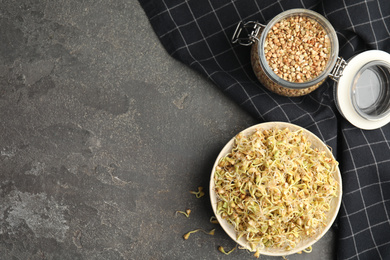 Photo of Flat lay composition with green buckwheat on grey table, space for text