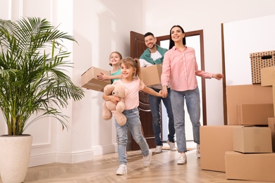 Happy family with children moving into new house