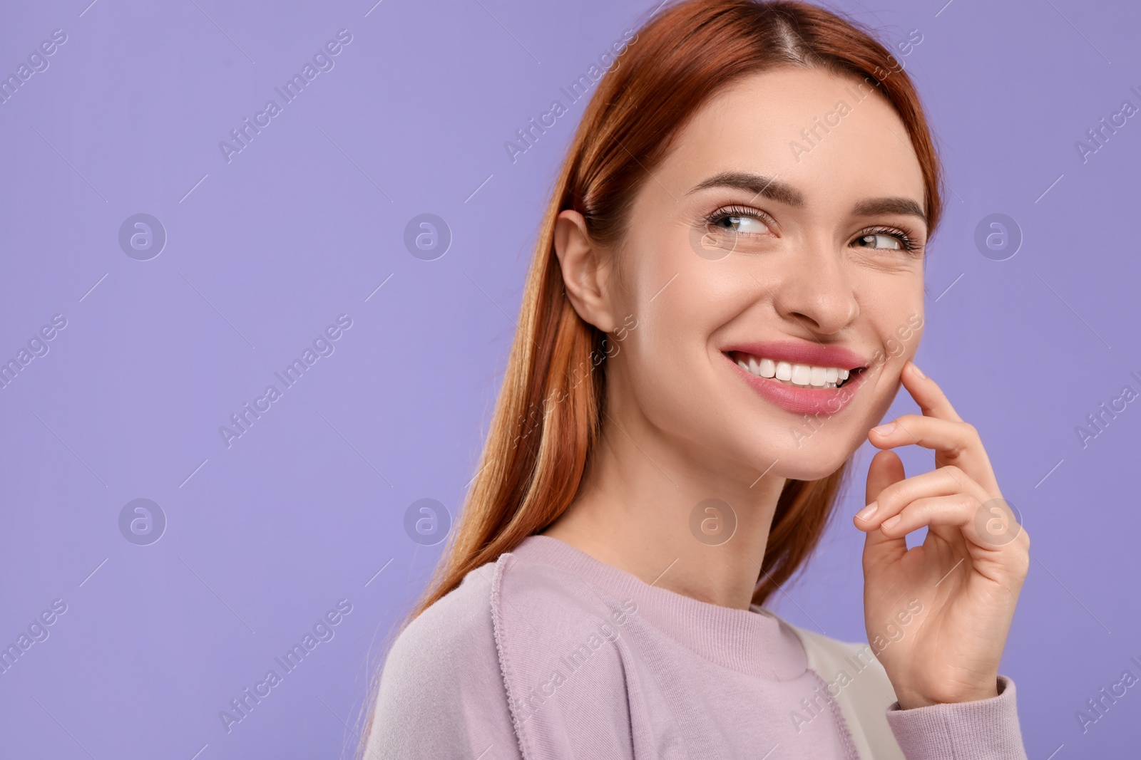 Photo of Beautiful woman with clean teeth smiling on violet background, space for text