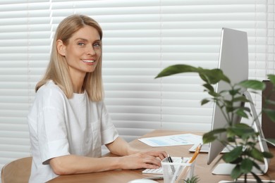 Photo of Professional accountant working at wooden desk in office