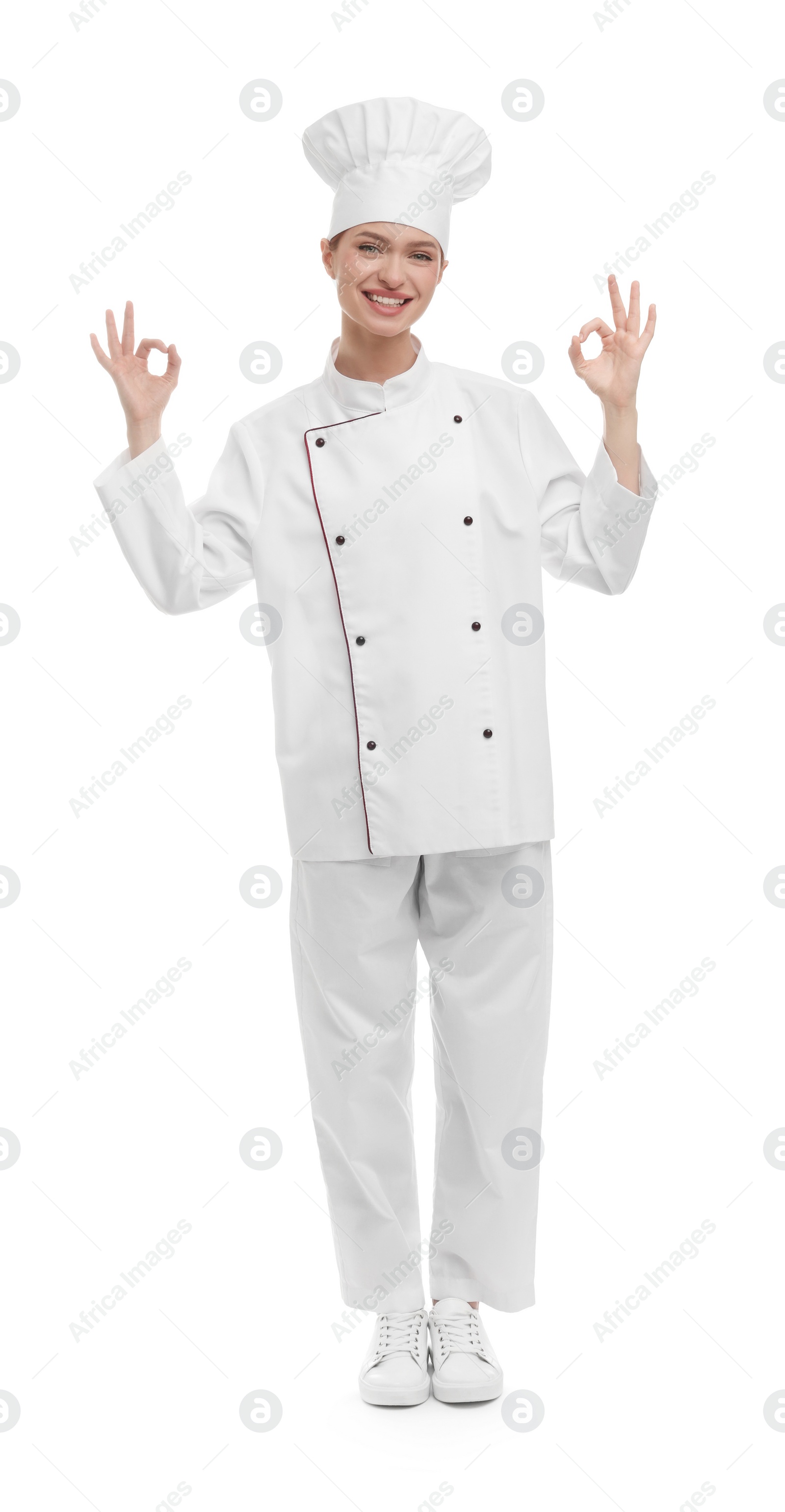 Photo of Happy woman chef in uniform showing OK gestures on white background