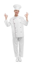 Photo of Happy woman chef in uniform showing OK gestures on white background