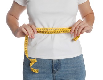Photo of Woman measuring waist with tape on white background, closeup