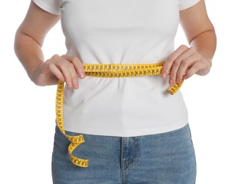 Woman measuring waist with tape on white background, closeup