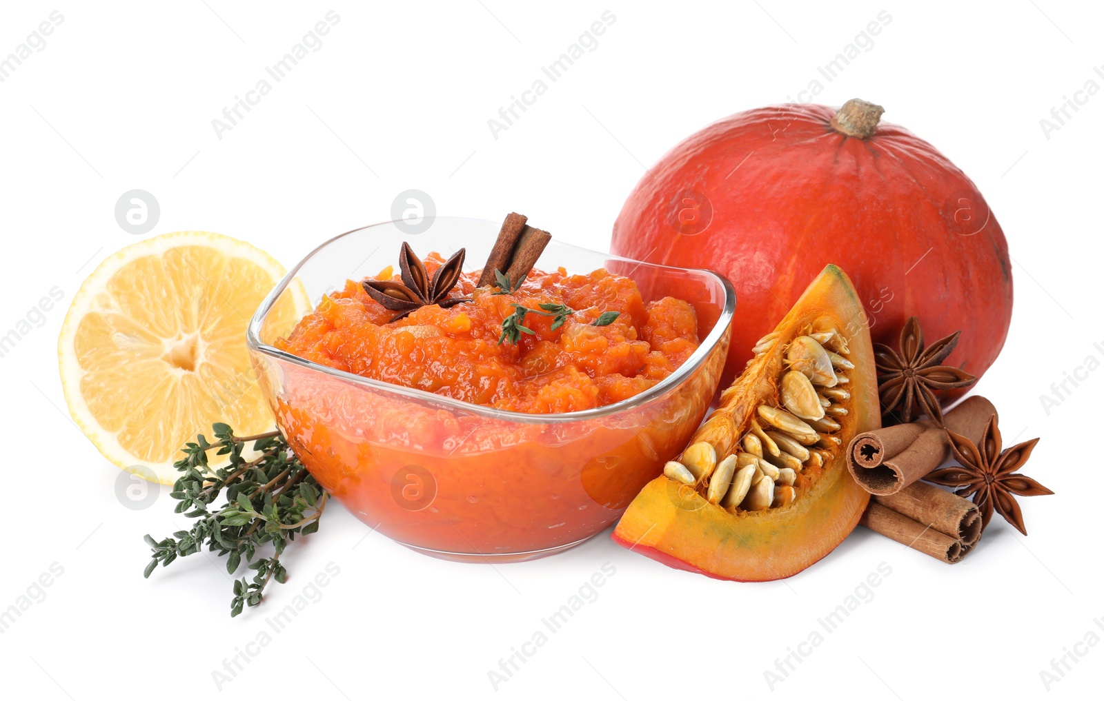 Photo of Glass bowl with pumpkin jam and ingredients on white background