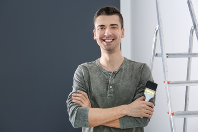 Portrait of male decorator with brush indoors