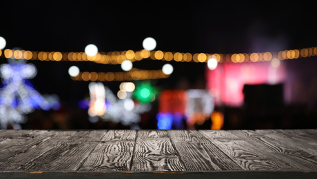Empty wooden surface against blurred lights. Bokeh effect 