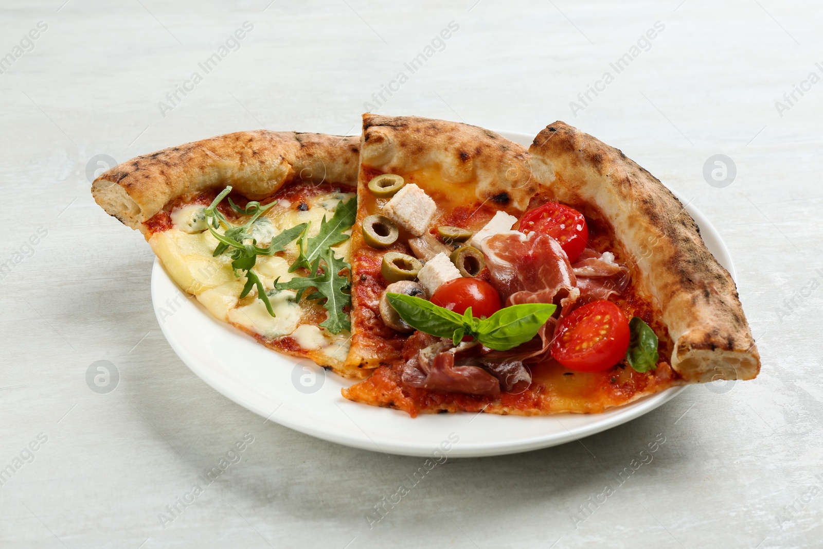 Photo of Slices of different delicious pizzas on light grey table