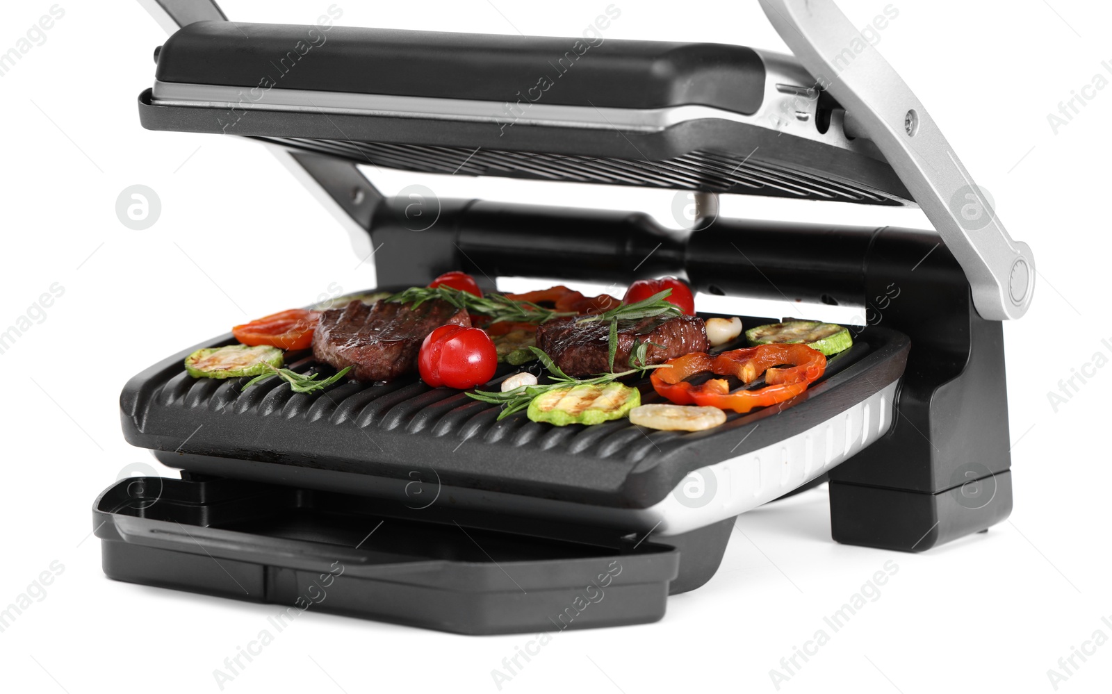 Photo of Electric grill with tasty meat, rosemary and vegetables isolated on white