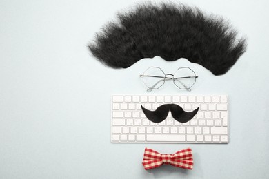 Photo of Flat lay composition with artificial moustache and glasses on light grey background, space for text