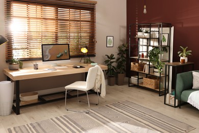 Light room interior with comfortable workplace near window