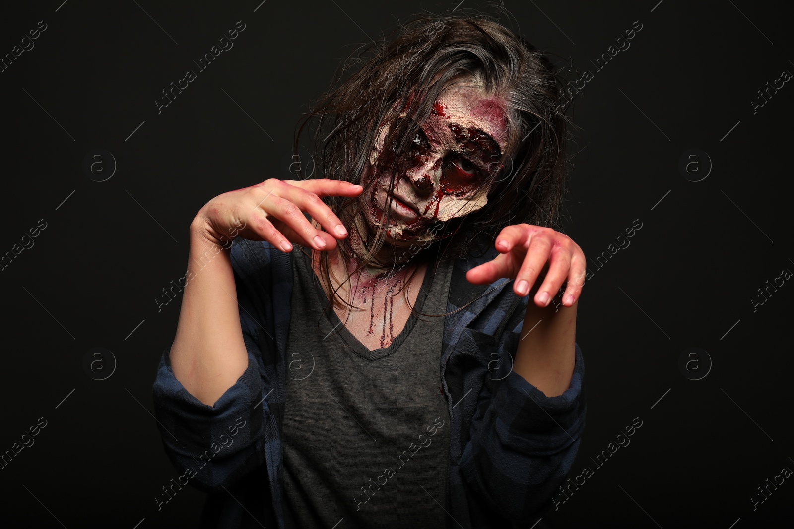 Photo of Scary zombie on dark background. Halloween monster