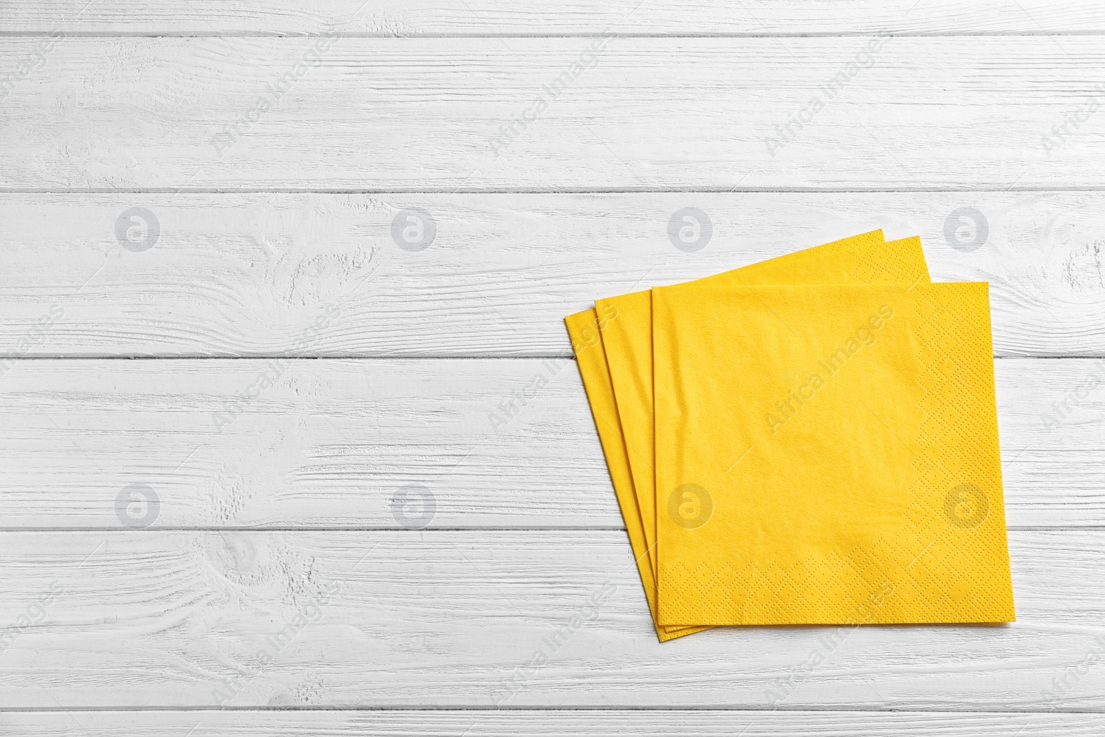 Photo of Clean napkins on wooden background, top view with space for text. Personal hygiene