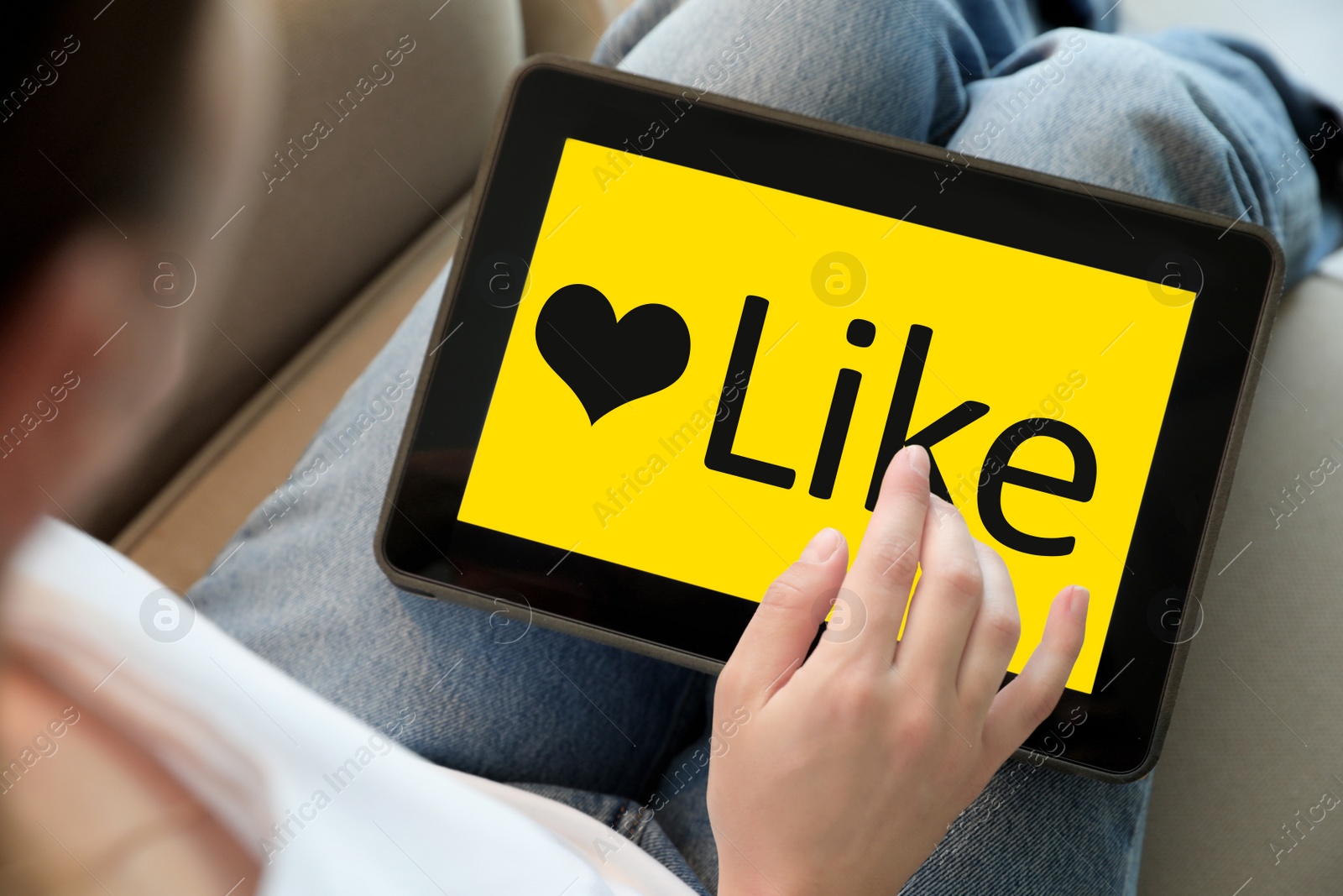 Image of Woman using tablet with word Like on screen indoors, closeup