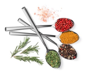 Metal spoons with different spices, salt and rosemary on white background, top view