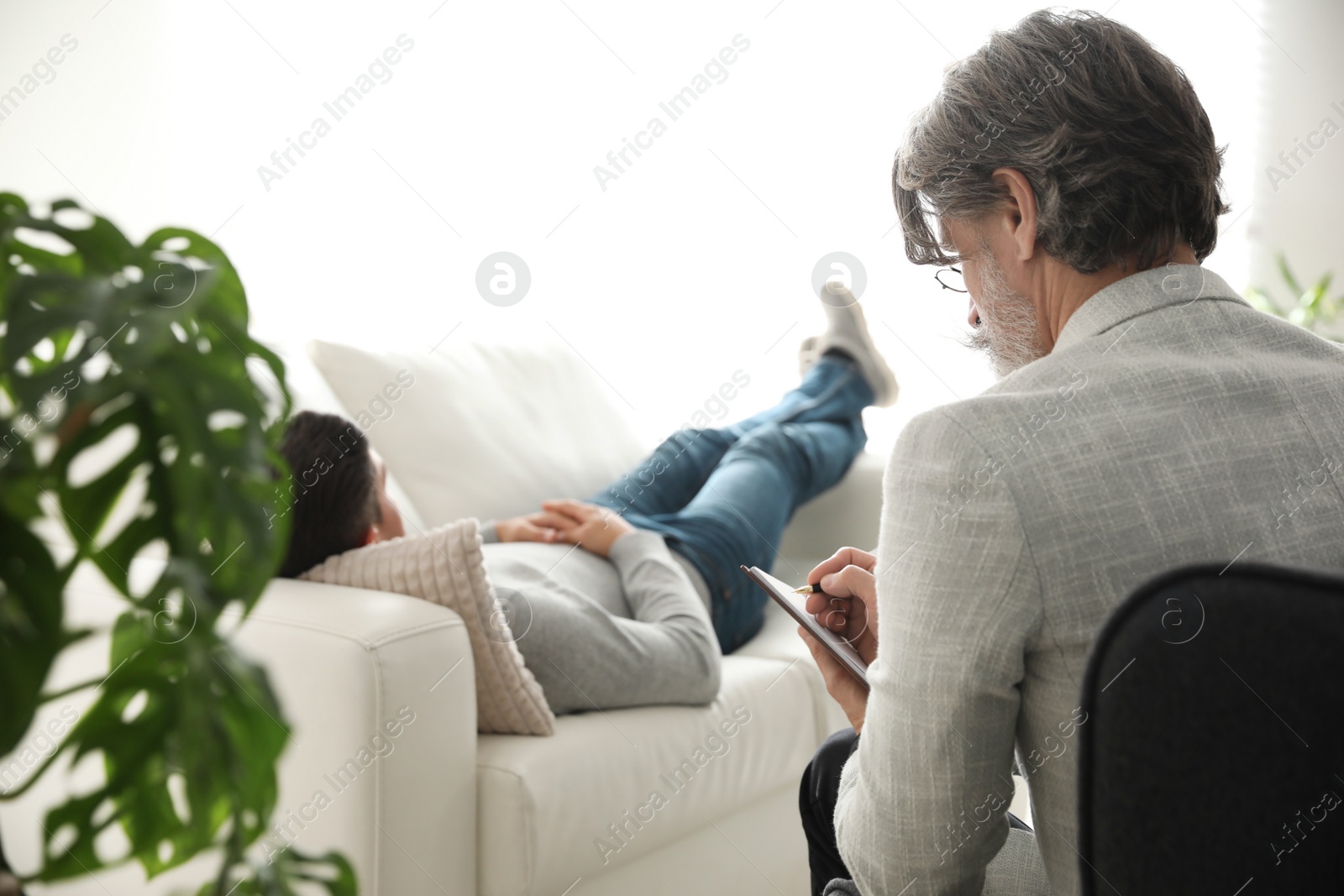 Photo of Psychotherapist and patient in office. Hypnotherapy session