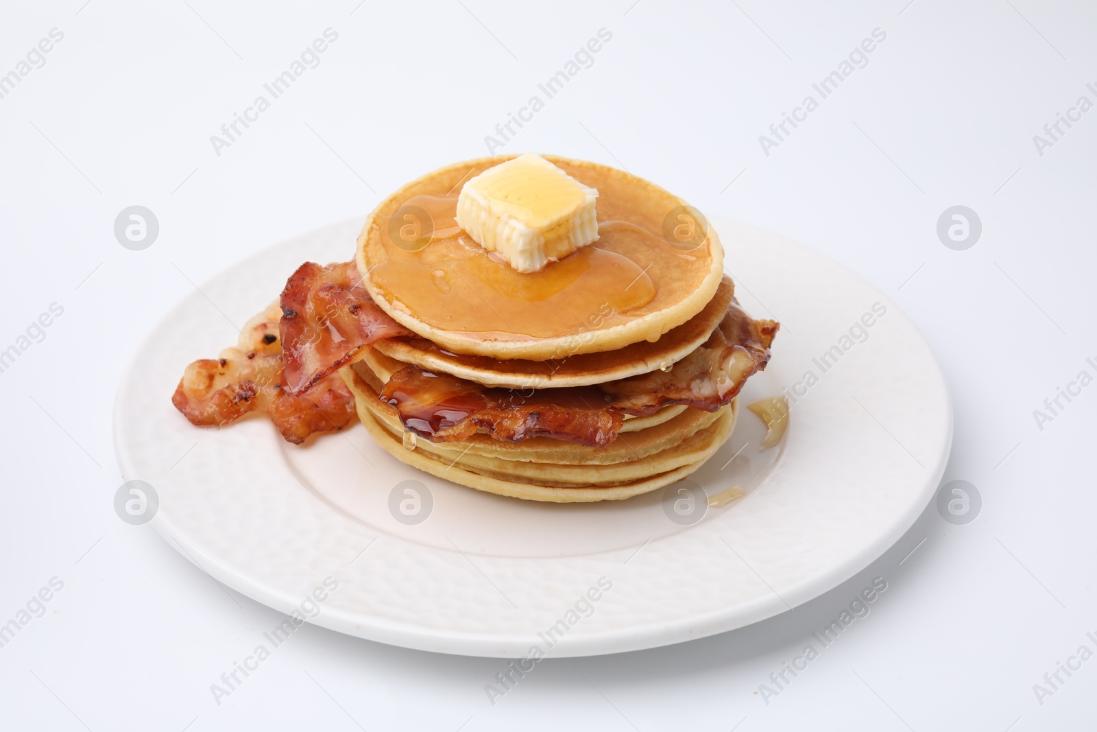 Photo of Delicious pancakes with bacon, butter and honey isolated on white