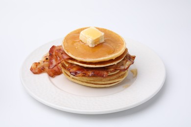 Delicious pancakes with bacon, butter and honey isolated on white