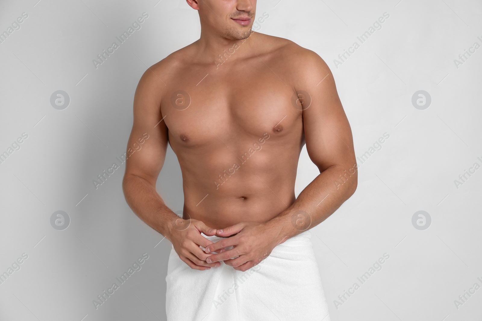 Photo of Man with sexy body on light background, closeup