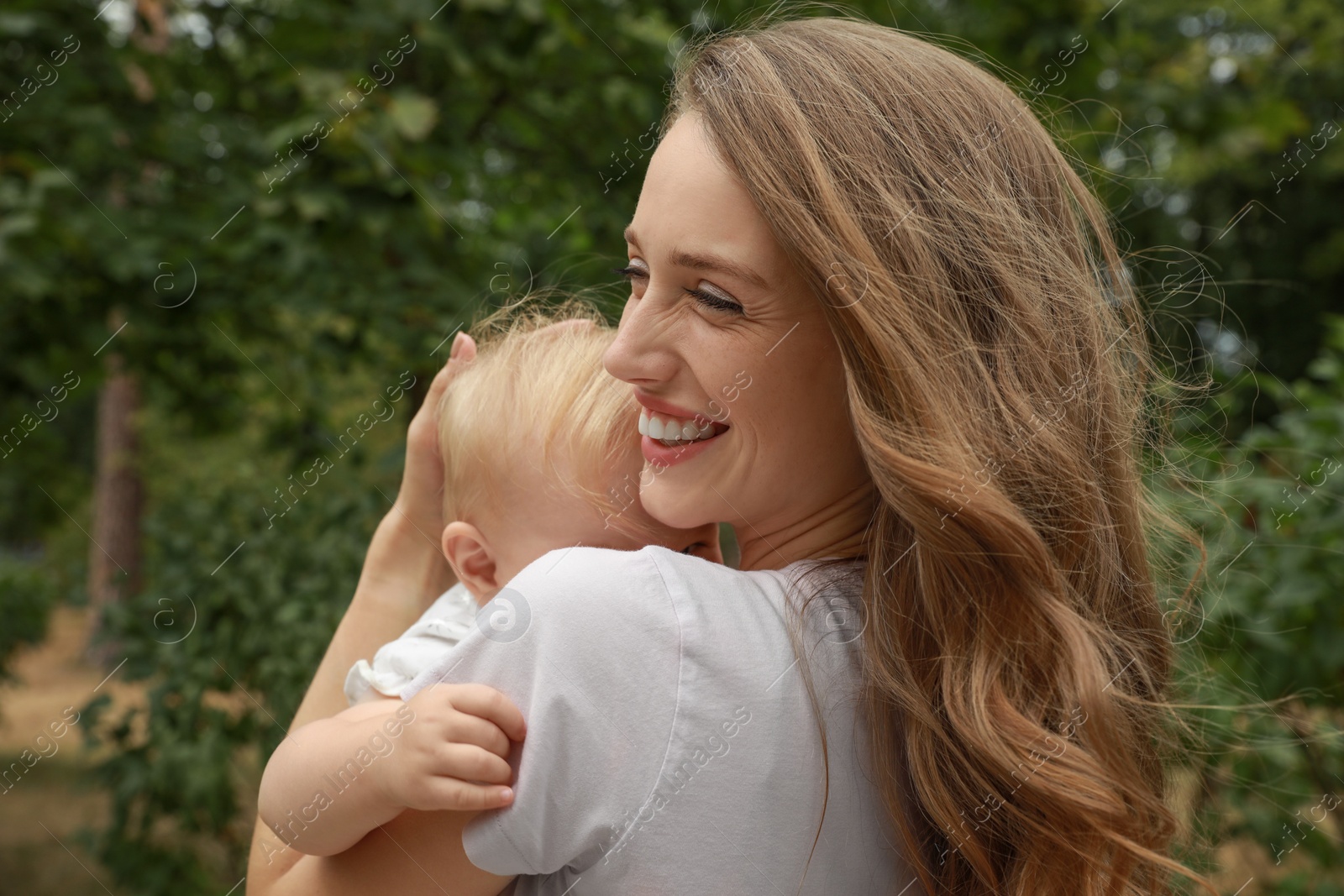 Photo of Mother with her cute baby spending time together outdoors