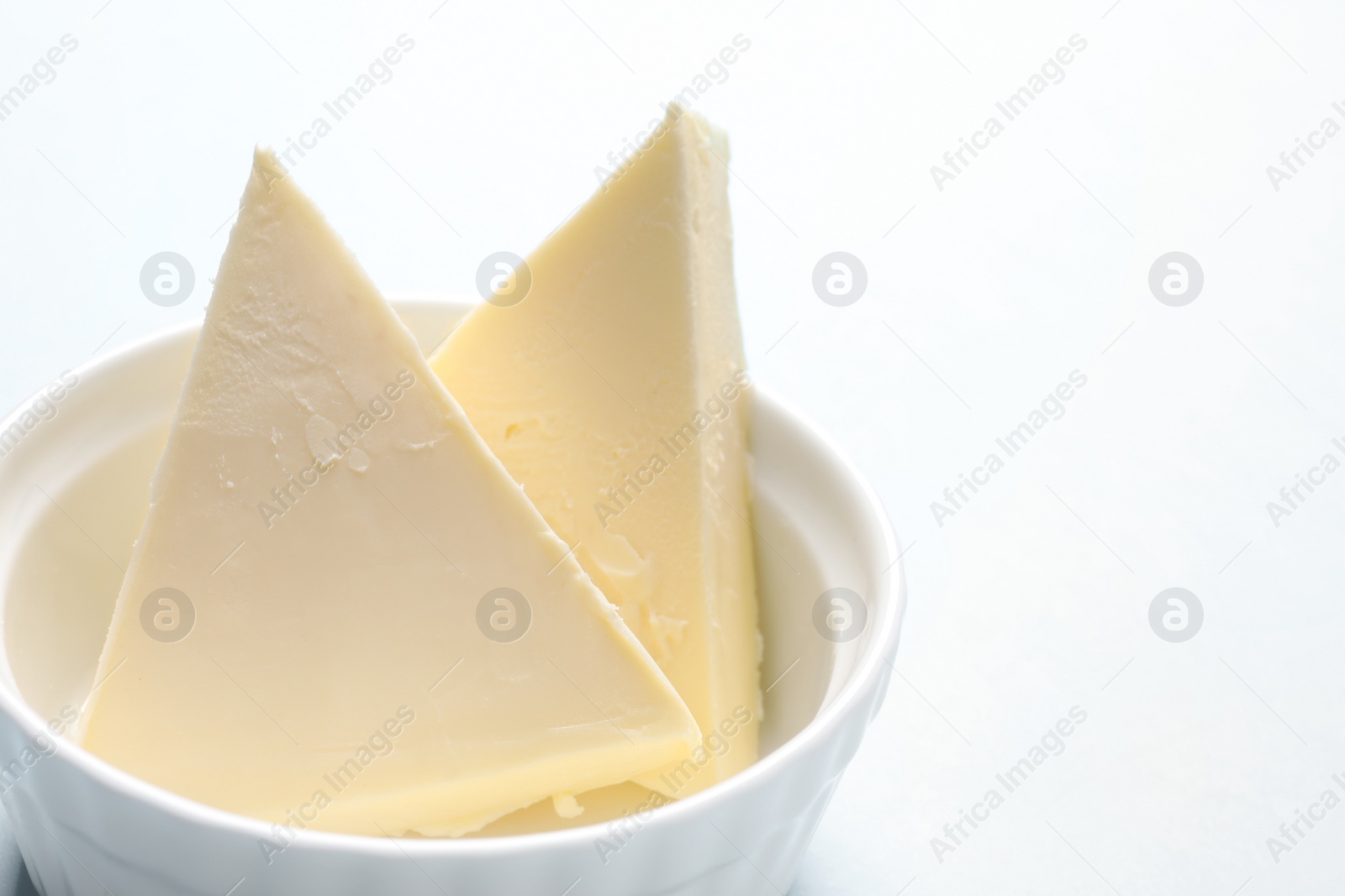 Photo of Dish with fresh butter on color background, closeup. Space for text